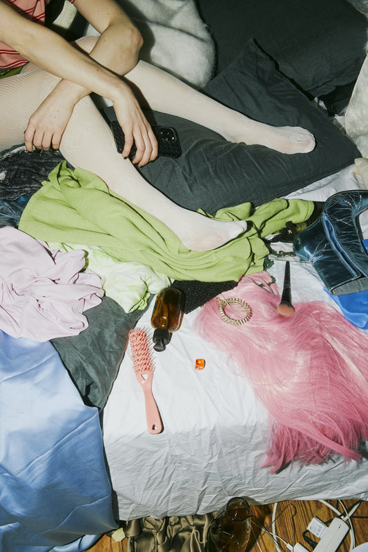 Excess clothing scattered on bed